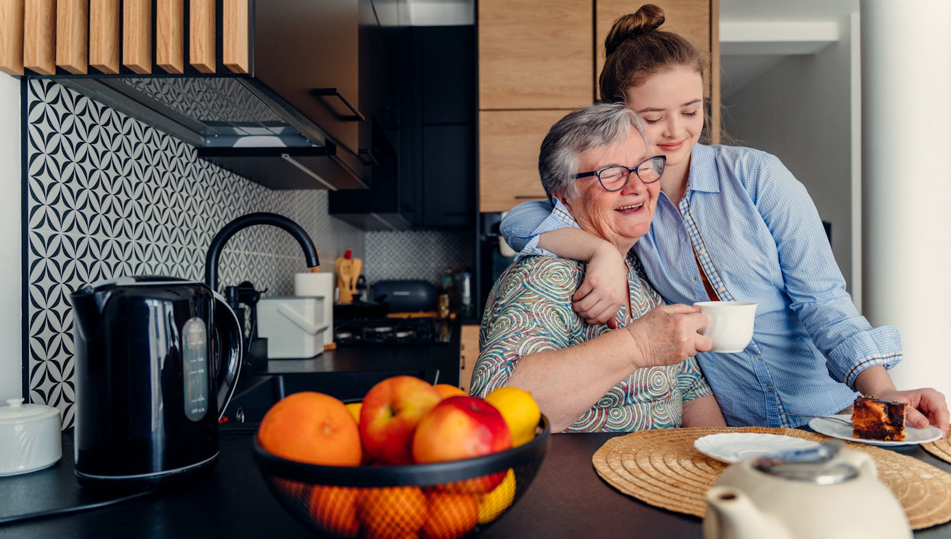 A young adult visits her grandmother.