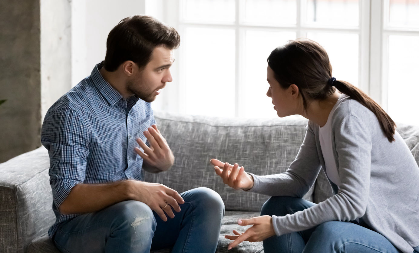 Two adults discuss something together.