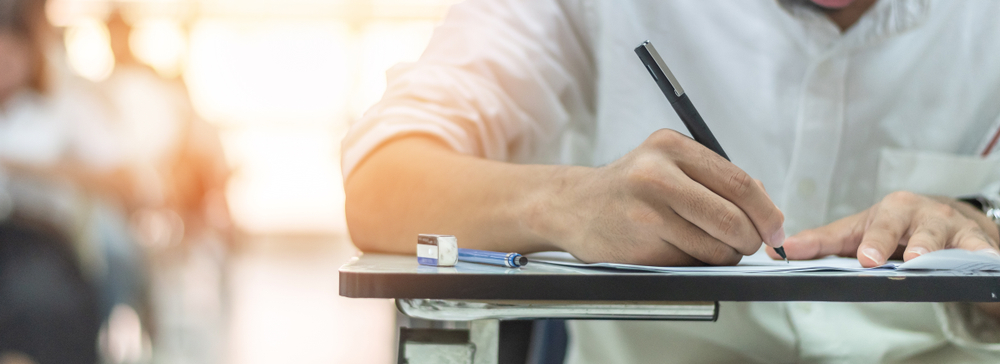 An adult studies at a table.